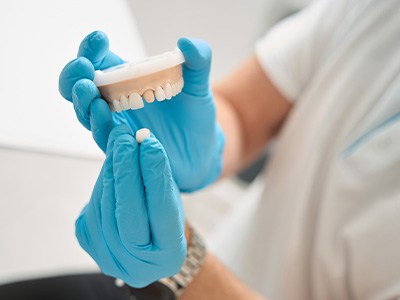 Dentist showing how a dental crown works