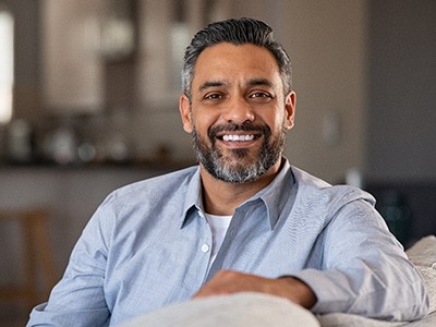 Man smiling with new dental crowns