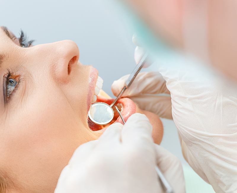 dentist conducting dental checkup on patient 