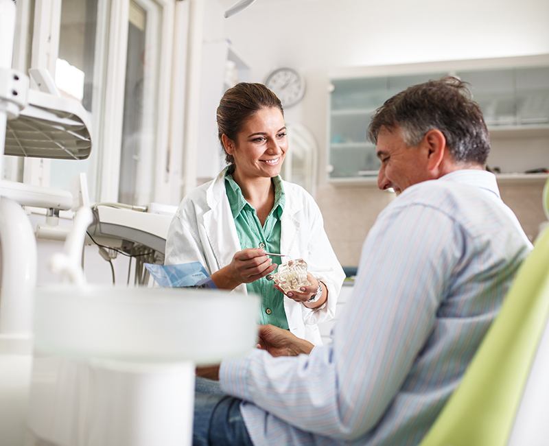 Dental team member explaining treatment to patient