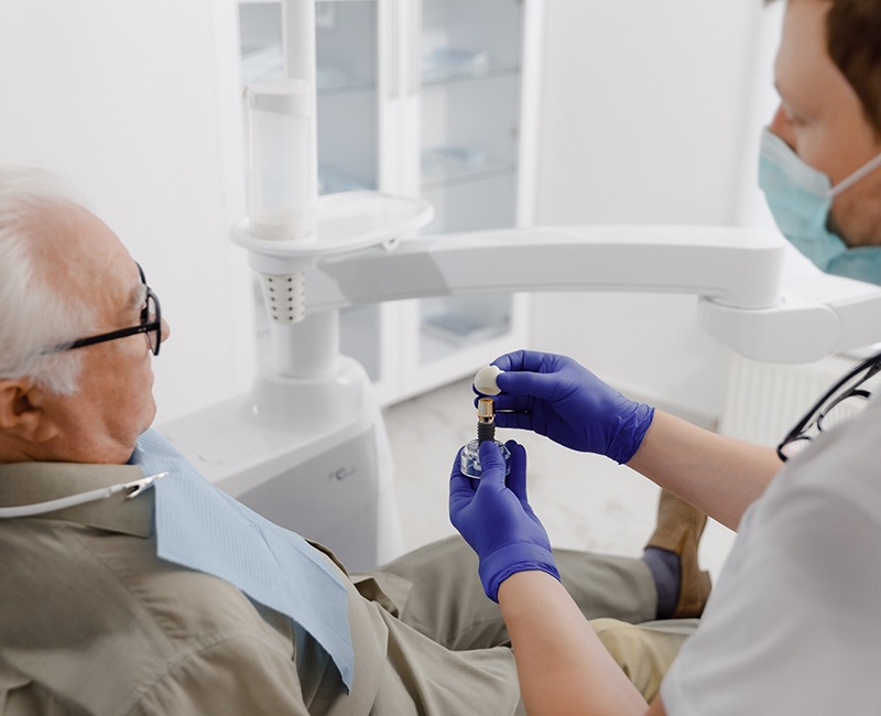 Dentist and patient talking during implant consultation