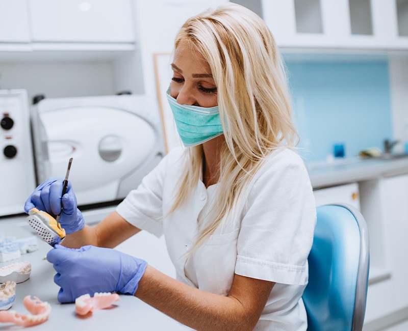 A lab technician making dentures