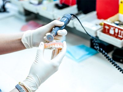 A technician working on a partial denture