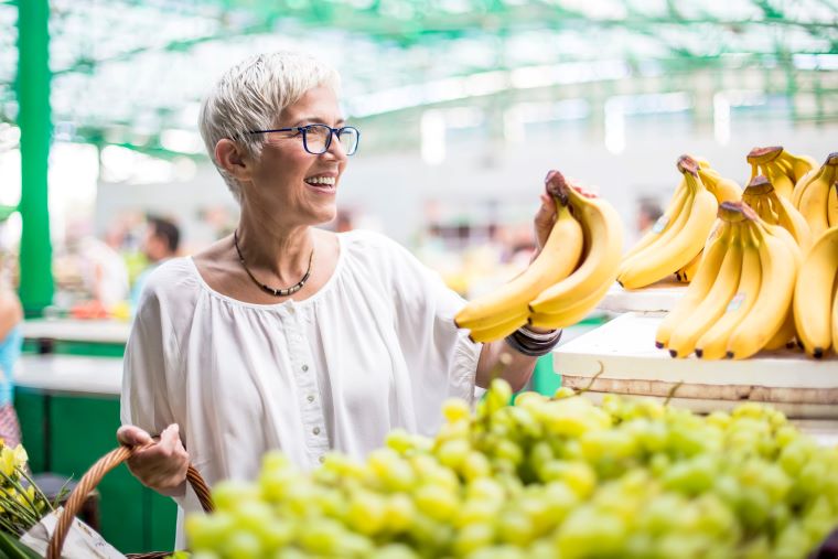 A woman buying bananas 